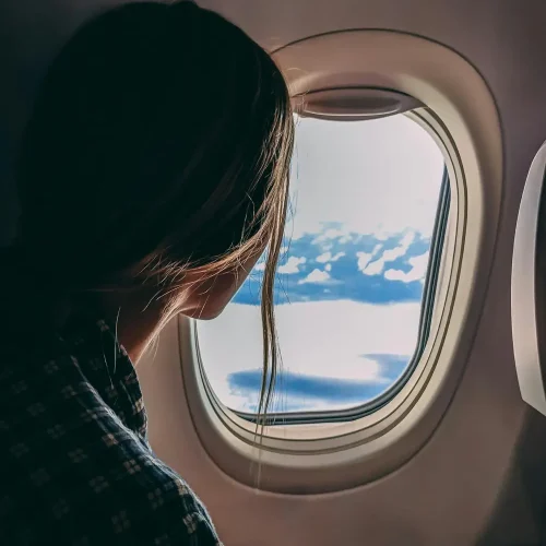 ladylookingoutofairplanewindow