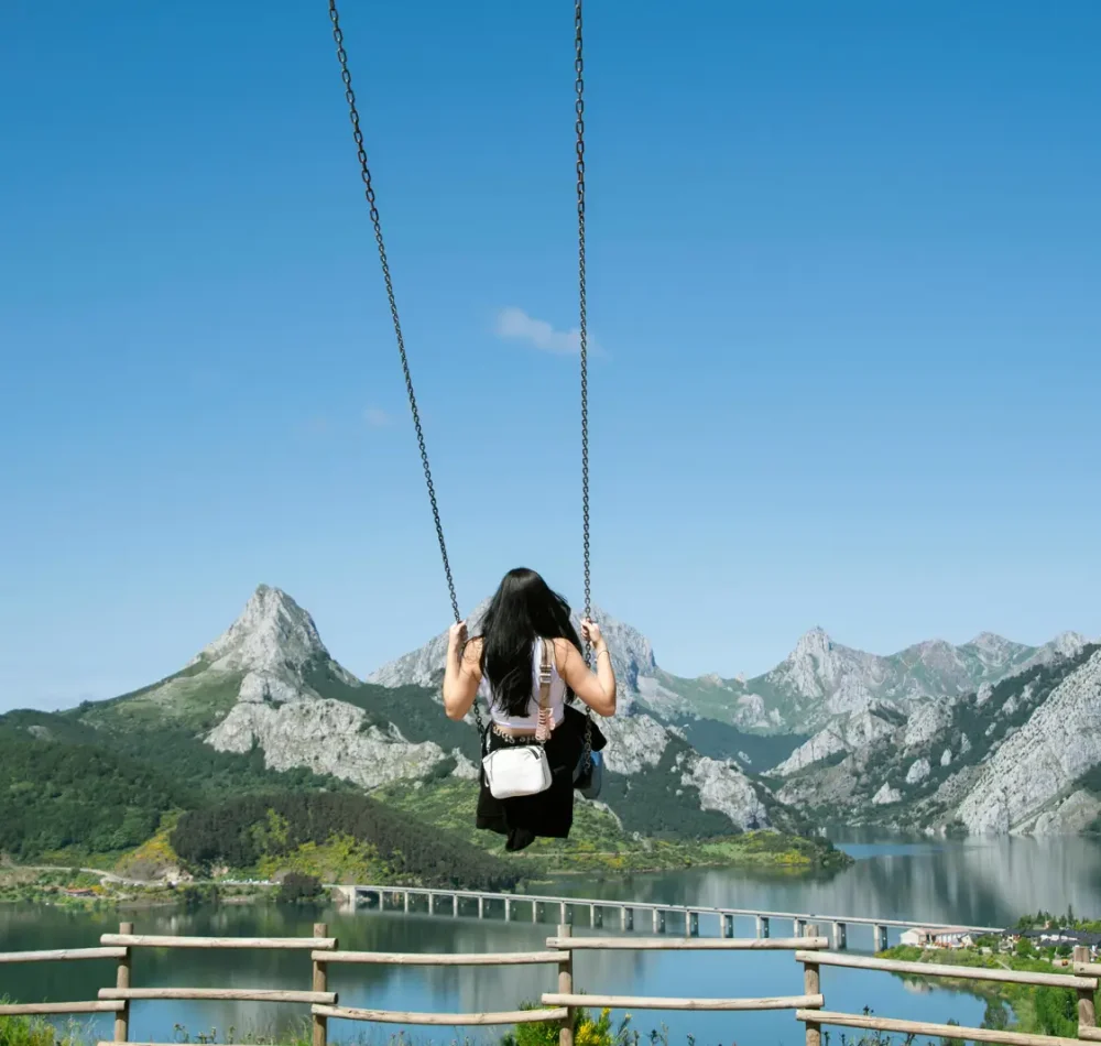 ladyswingingoverbeautifullandscape